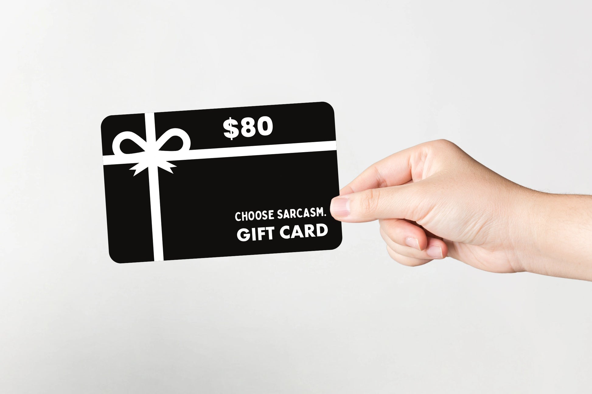 Flat lay of CHOOSE SARCASM gift card valued at $80.
